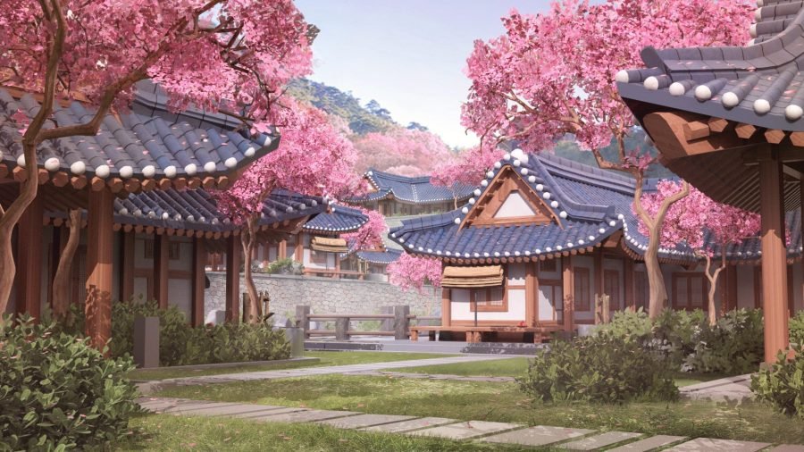 Traditional Korean architecture in daylight with blossom trees.